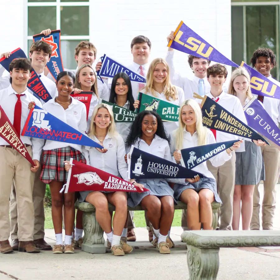 A group of Dunham seniors holding college pennants.