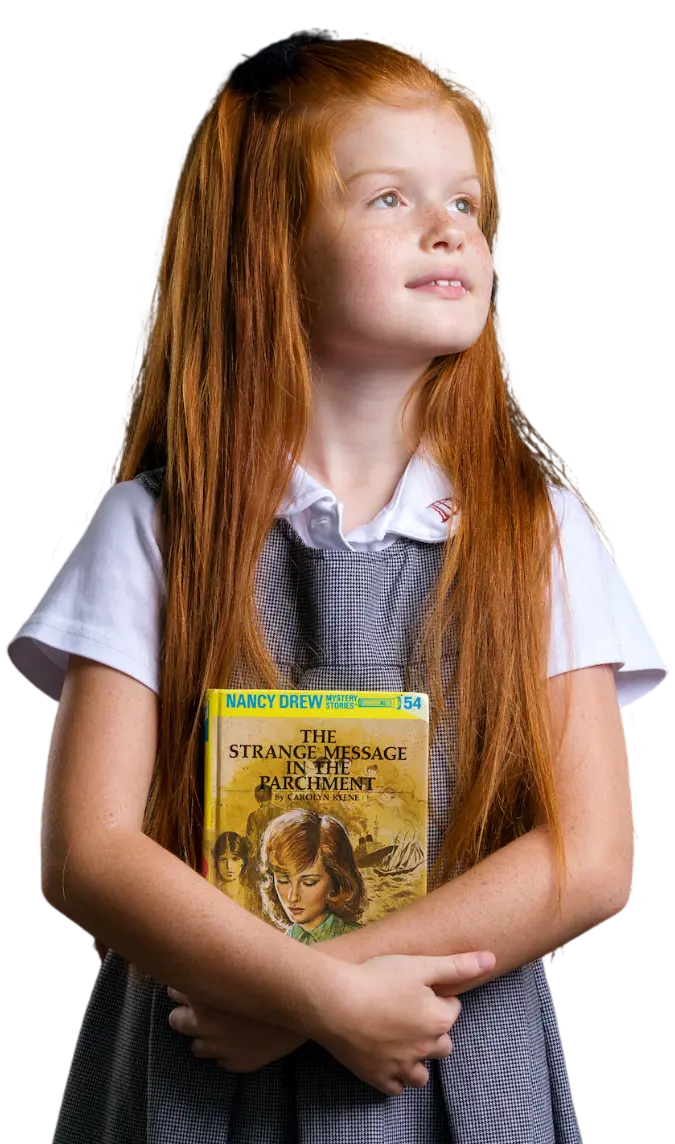 Dunham Lower School girl holding a book