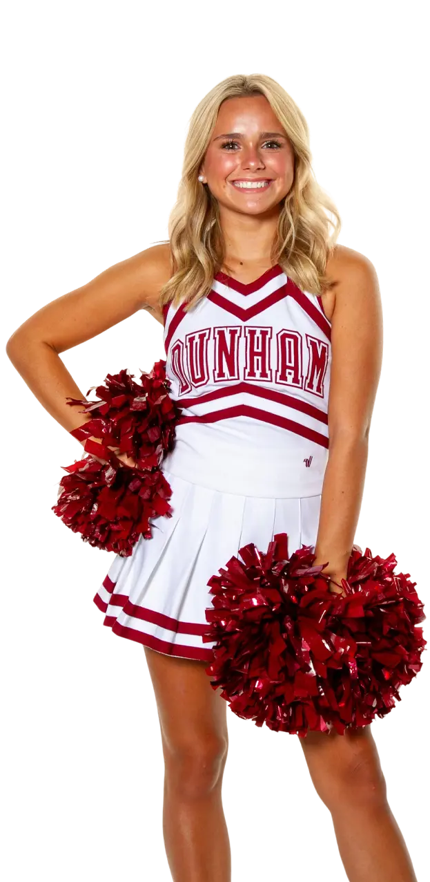 A Dunham high school cheerleader standing with pom poms.