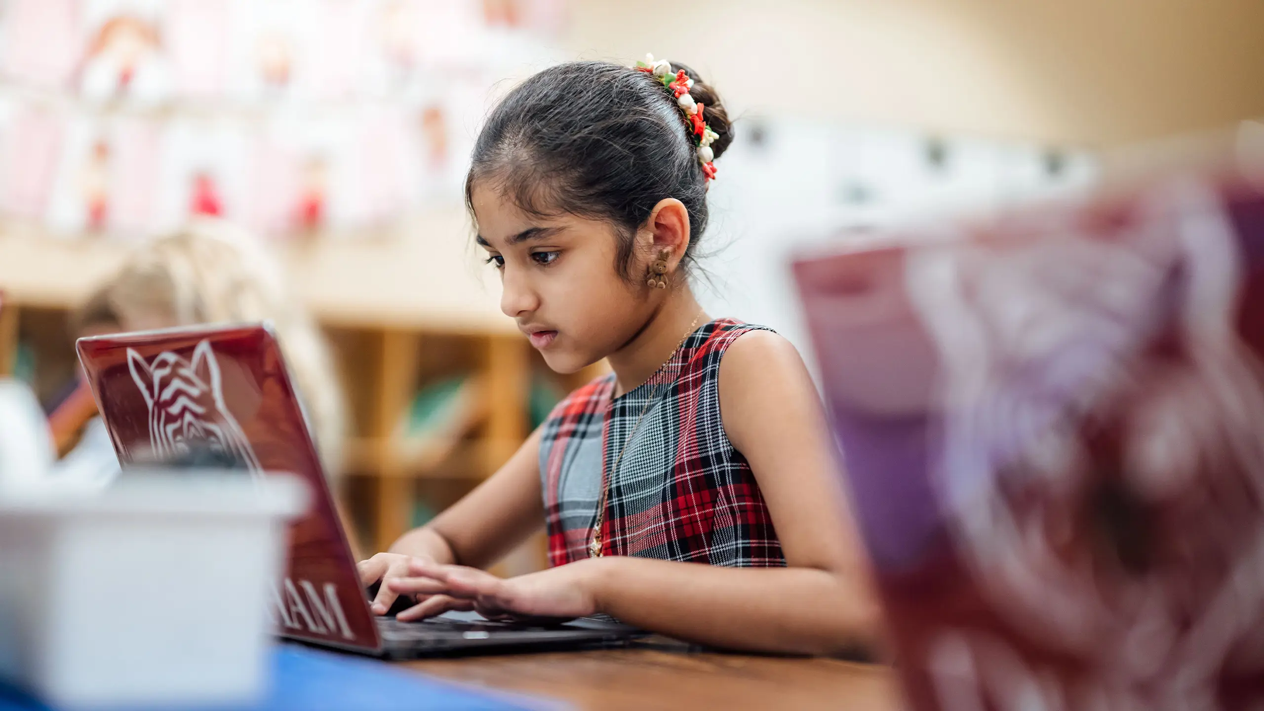 Lower school girl learning on Macbook.