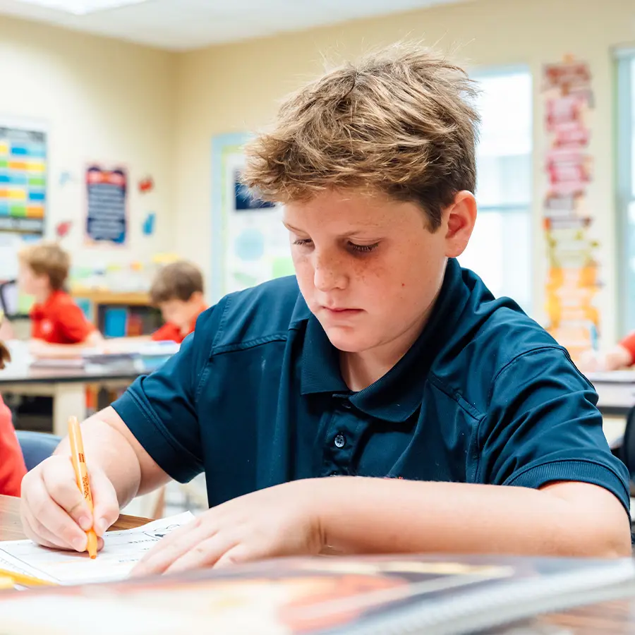 Lower school boy doing school work.