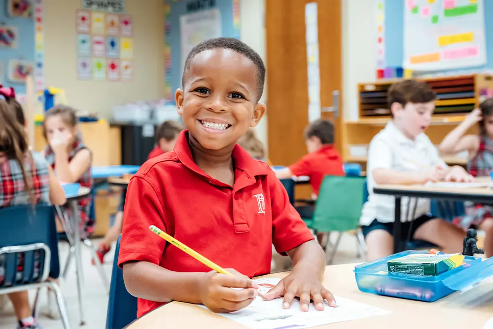 Male lower school student working in classroom.