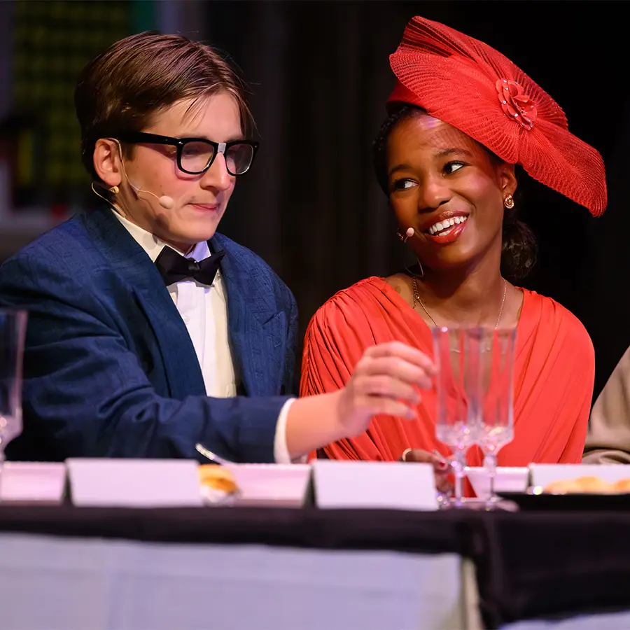 Two high school theatre performers acting.