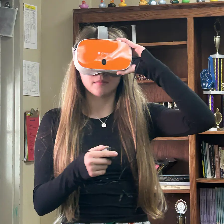 Dunham upper school student using VR goggles.