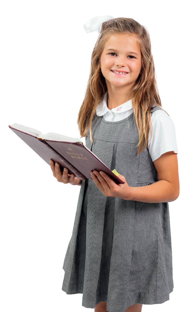 A Dunham lower school girl holding a book